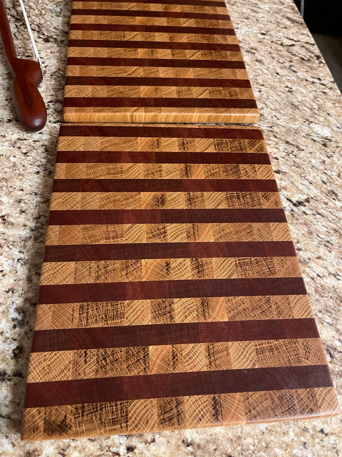 Classic striped end grain cutting board with contrasting light and dark hardwoods