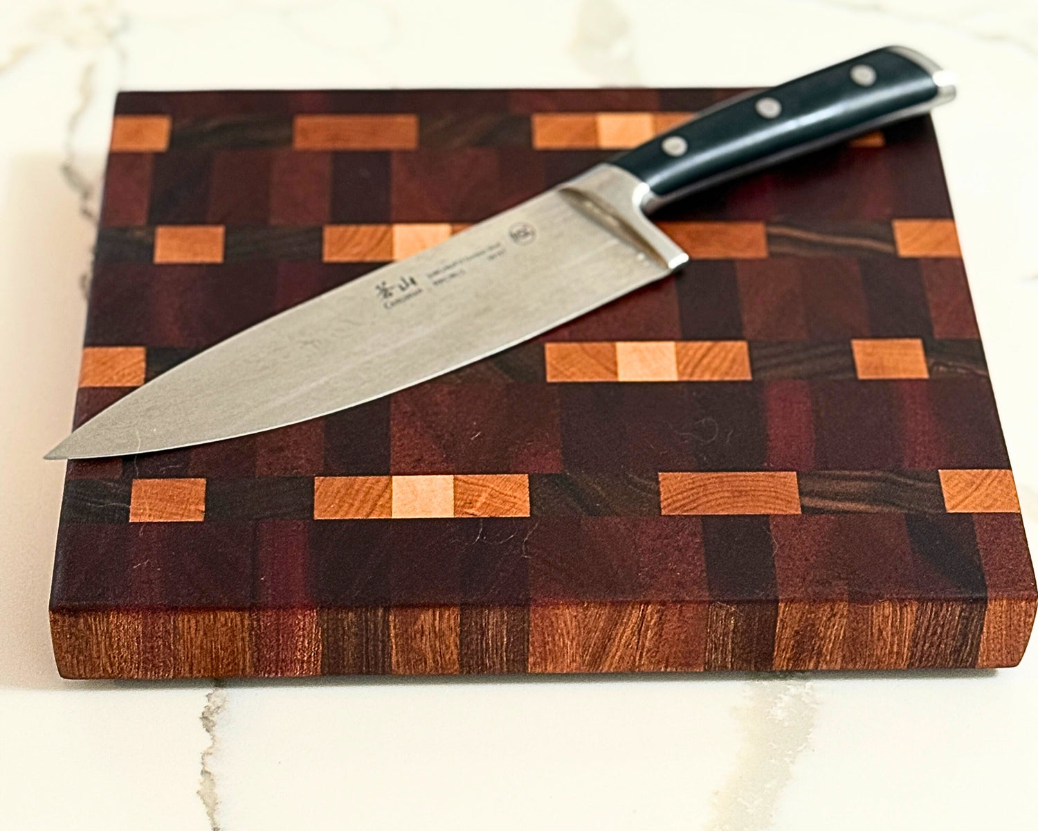 Solid wood cutting board with natural grain variation, handcrafted by Hoeksema Woodworking