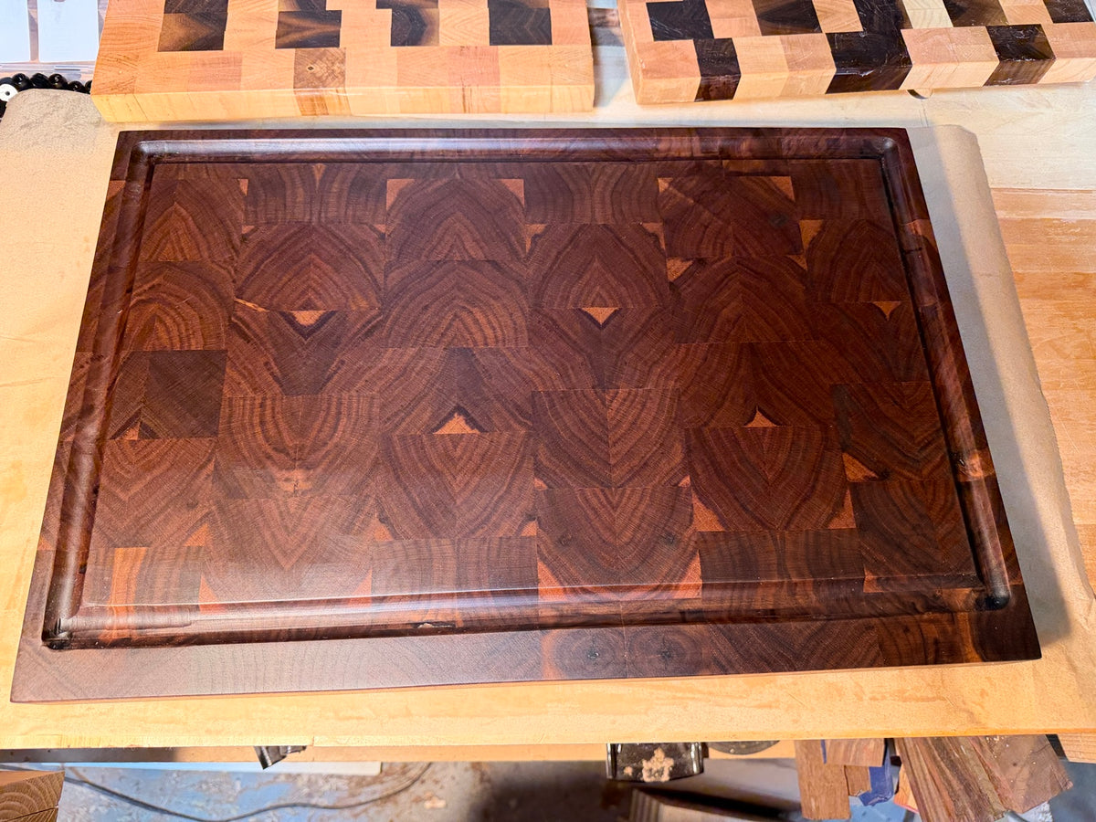 Handcrafted end grain cutting board with a routed juice groove around the perimeter